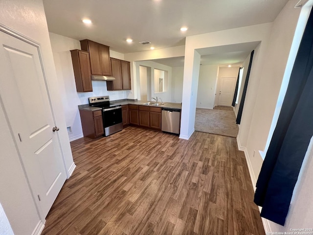 kitchen featuring dark wood-type flooring, sink, and stainless steel appliances