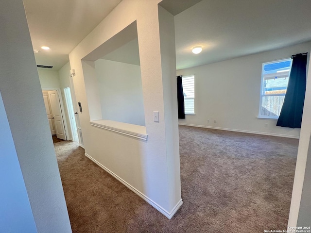 corridor with carpet flooring and plenty of natural light