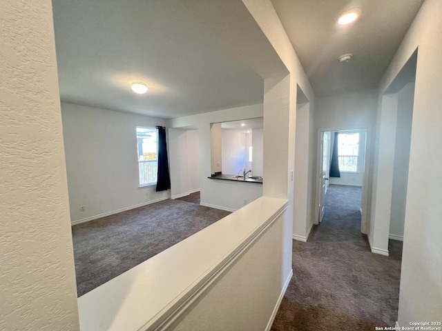 hallway with dark carpet