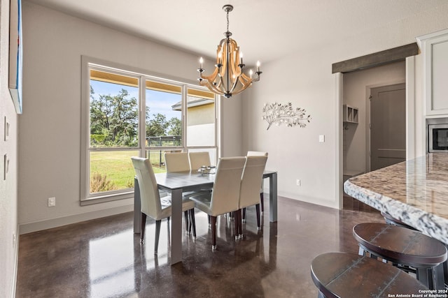 dining room featuring an inviting chandelier and plenty of natural light