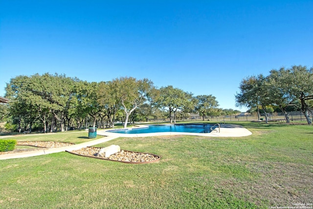 view of pool featuring a yard