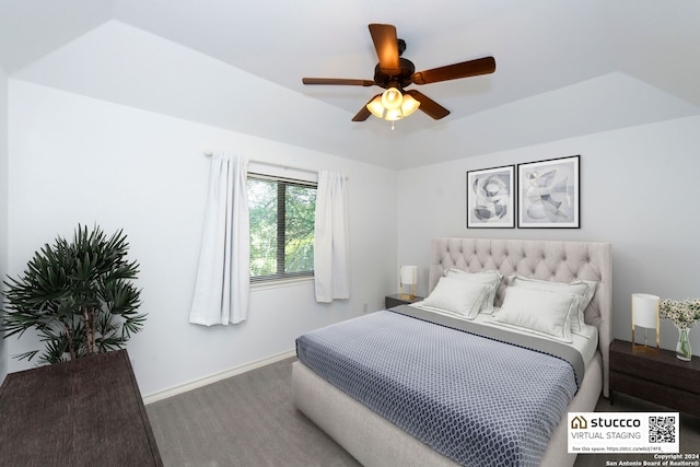 bedroom with wood-type flooring, a tray ceiling, and ceiling fan