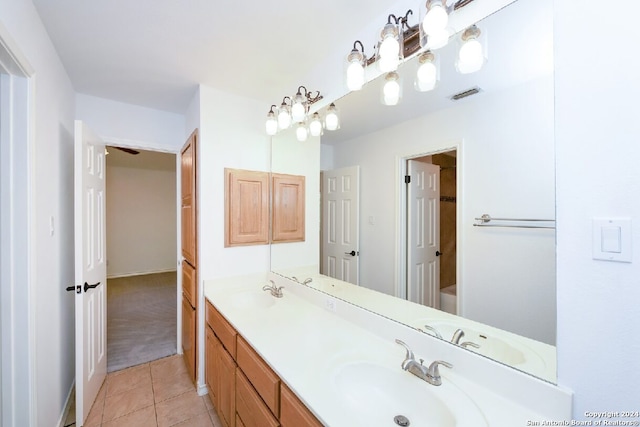 bathroom with vanity, a bath, and tile patterned floors