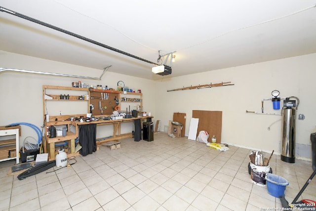 garage with a garage door opener and a workshop area