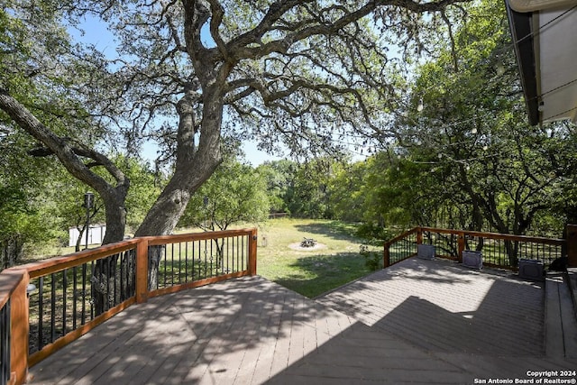 wooden terrace featuring a yard