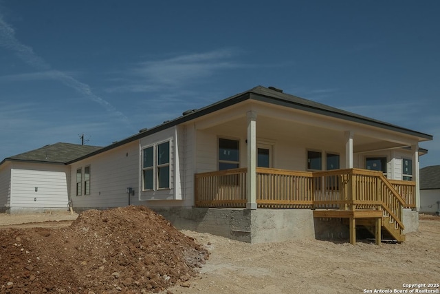 rear view of property featuring a porch