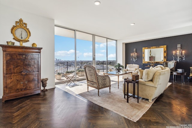 living room with dark parquet floors and a wall of windows