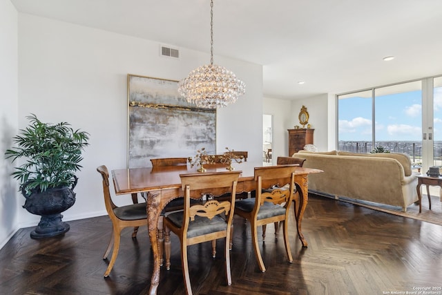 dining space with a chandelier, dark parquet flooring, and expansive windows