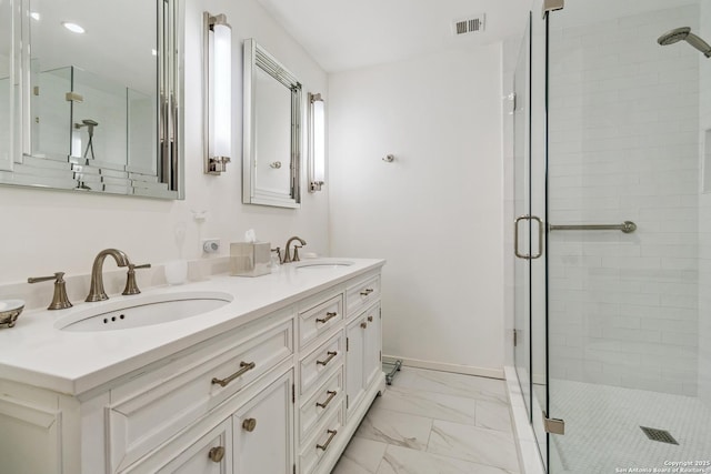 bathroom with vanity and a shower with shower door