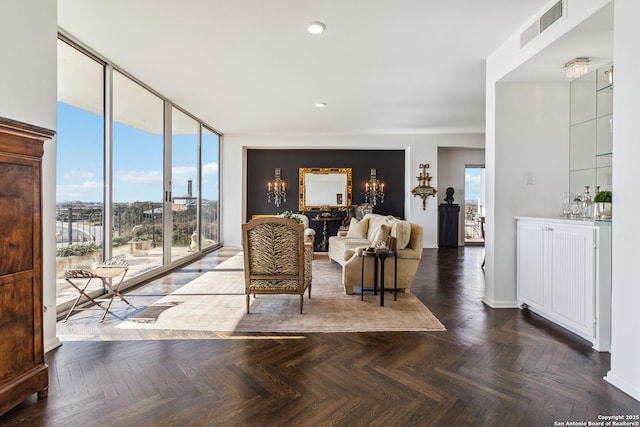 living room featuring dark parquet flooring and floor to ceiling windows