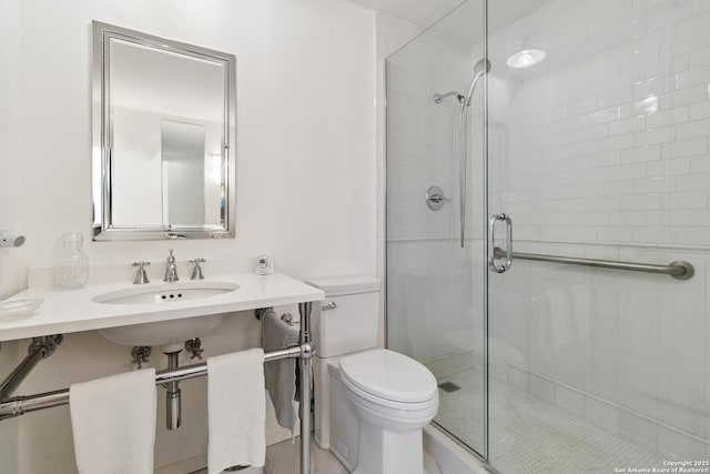 bathroom with toilet, sink, and walk in shower