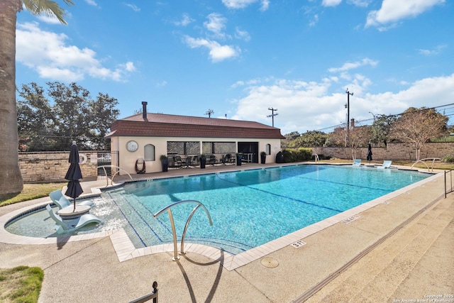 view of swimming pool with a patio area