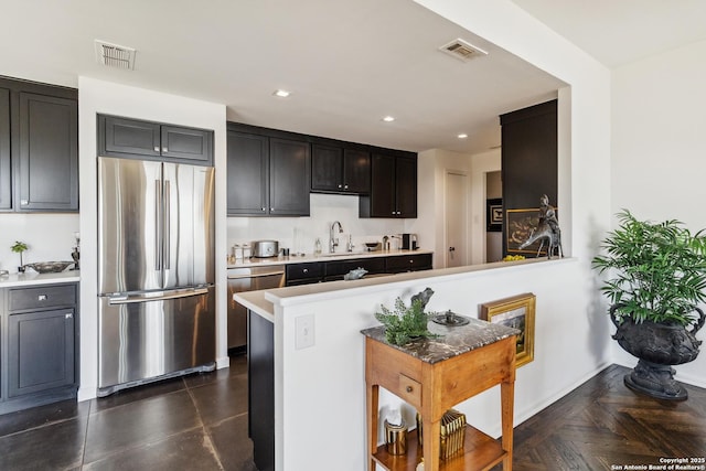 kitchen featuring sink, dark parquet floors, and stainless steel appliances