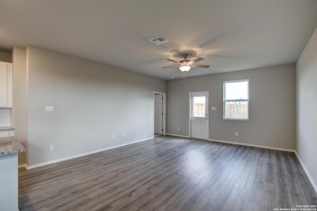 empty room featuring dark hardwood / wood-style flooring and ceiling fan