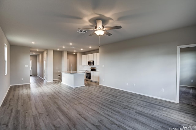 unfurnished living room with ceiling fan, sink, and wood-type flooring