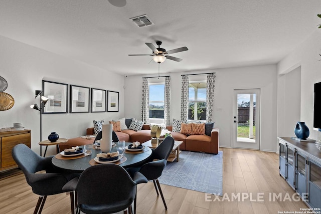 dining area featuring plenty of natural light, ceiling fan, a textured ceiling, and light hardwood / wood-style flooring