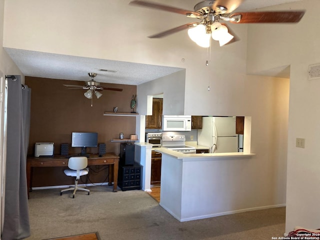 kitchen featuring white appliances, ceiling fan, a textured ceiling, light colored carpet, and kitchen peninsula