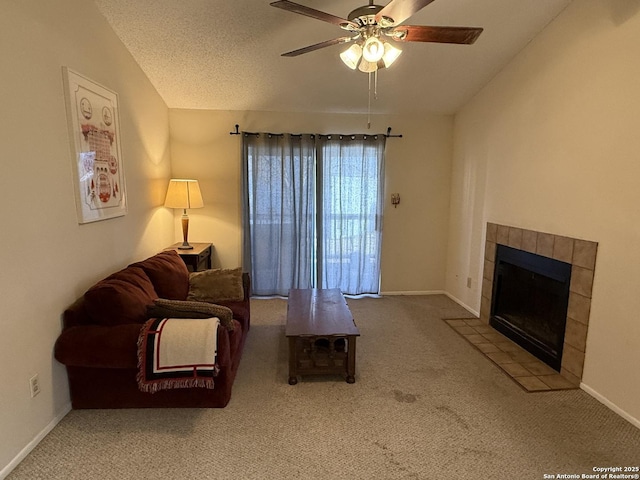 living room with a fireplace, a textured ceiling, carpet floors, and ceiling fan