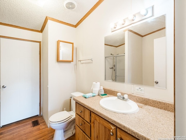 bathroom with walk in shower, ornamental molding, a textured ceiling, toilet, and hardwood / wood-style flooring