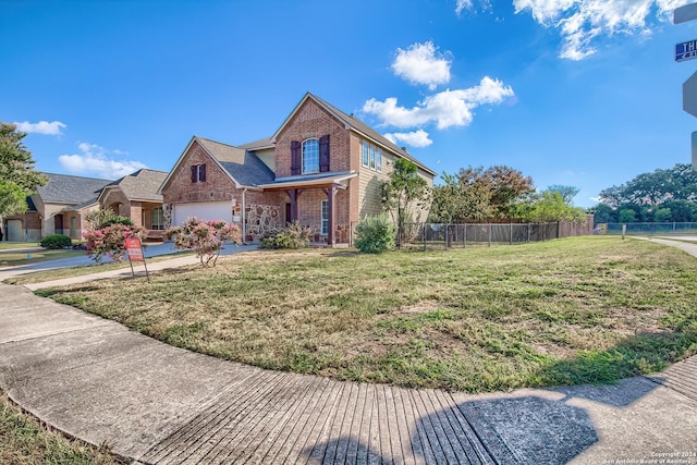 front of property featuring a front yard and a garage