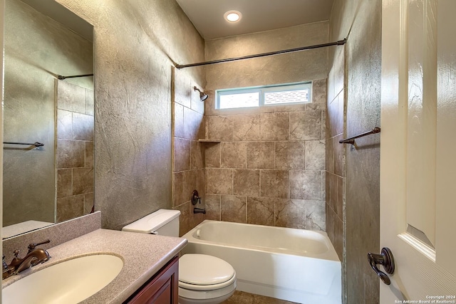 full bathroom with toilet, vanity, and tiled shower / bath