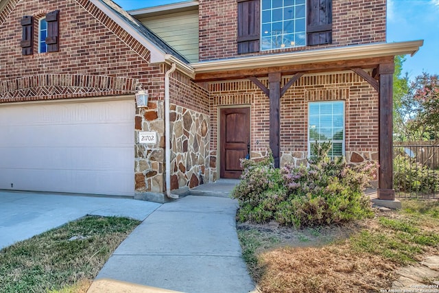 view of exterior entry with a garage