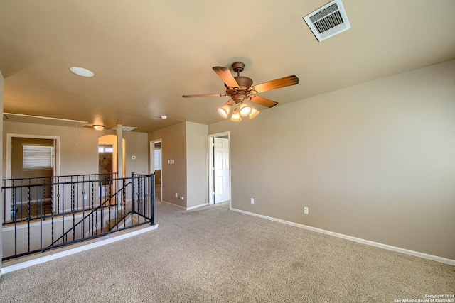 unfurnished room with light colored carpet and ceiling fan