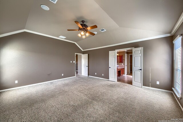 unfurnished bedroom with ceiling fan, carpet, lofted ceiling, and ornamental molding