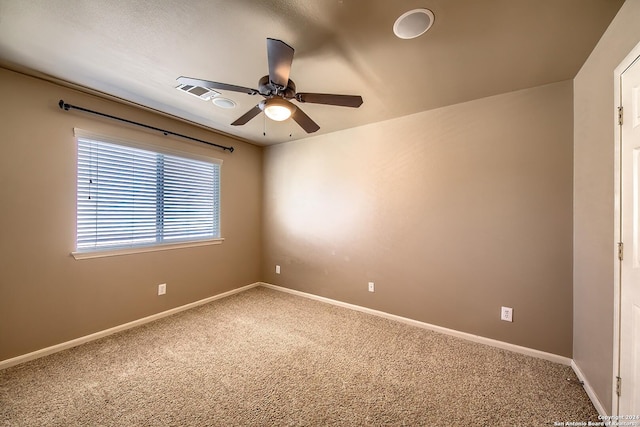 unfurnished room featuring ceiling fan and carpet floors