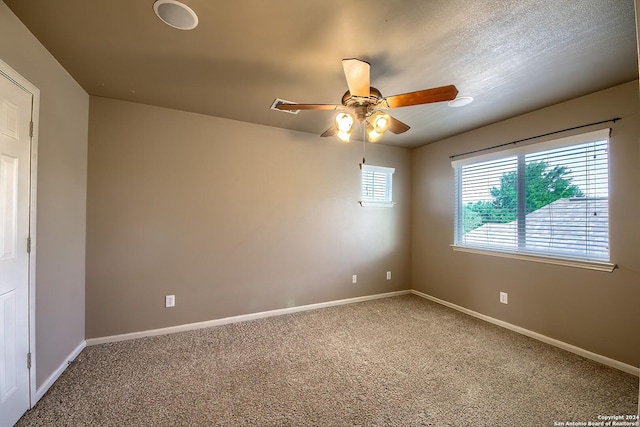 carpeted spare room with ceiling fan