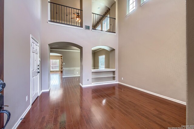 foyer with a high ceiling and hardwood / wood-style flooring