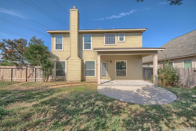 back of property featuring a yard and a patio