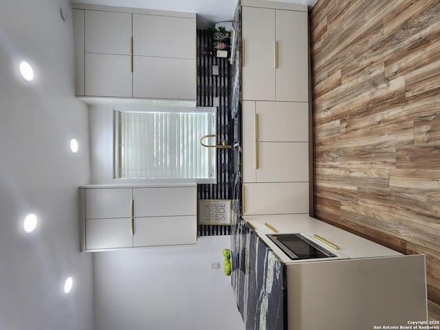 kitchen featuring wooden walls