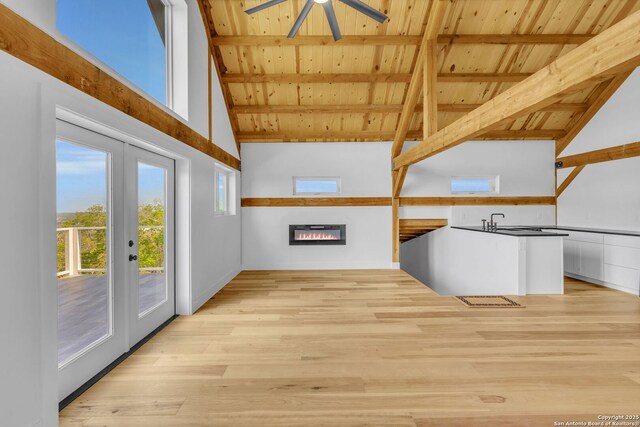 interior space with beamed ceiling, french doors, ceiling fan, and wooden ceiling