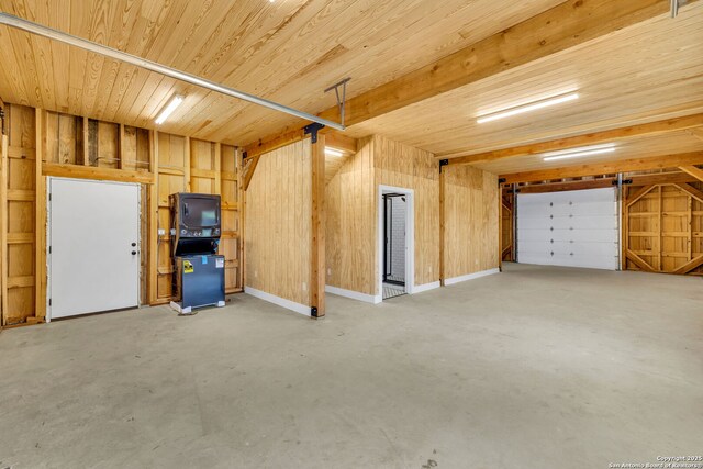 garage featuring wood walls