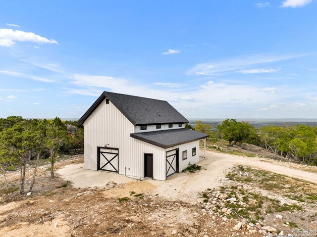 view of home's exterior with an outdoor structure