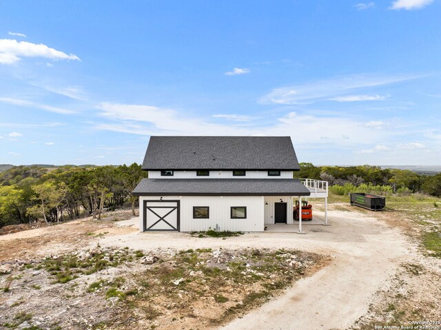 modern farmhouse style home featuring an outdoor structure