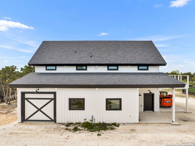 exterior space with a garage and an outbuilding