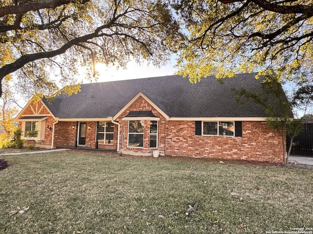 ranch-style home featuring a front yard