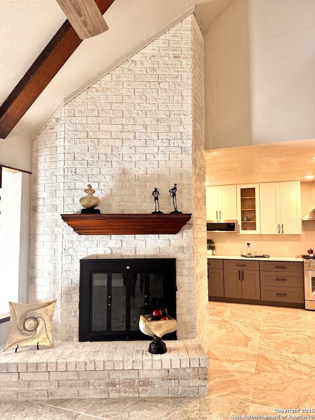 room details with beam ceiling, gas range, and a fireplace