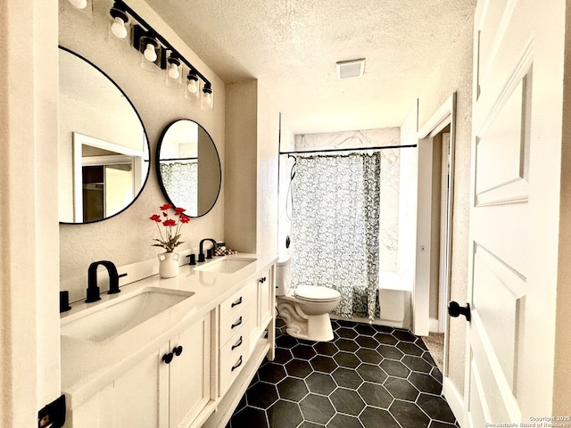 full bathroom with shower / bath combination with curtain, toilet, a textured ceiling, and vanity