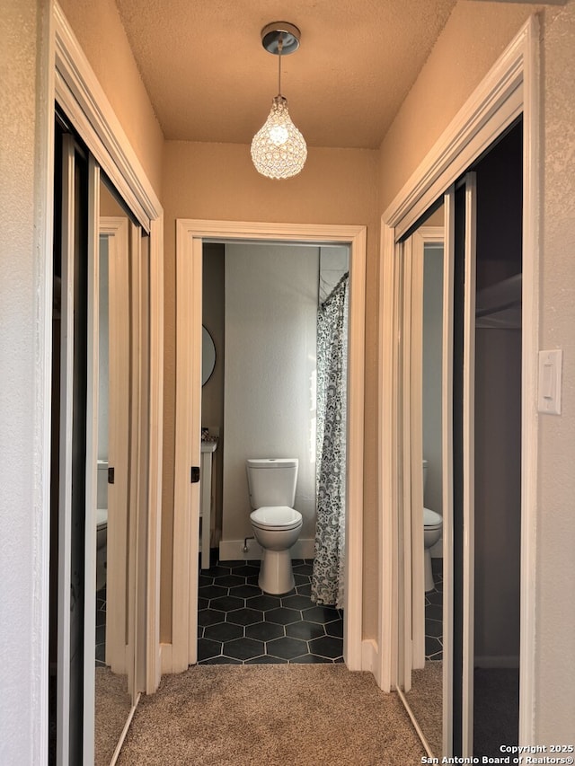 bathroom featuring a textured ceiling and toilet