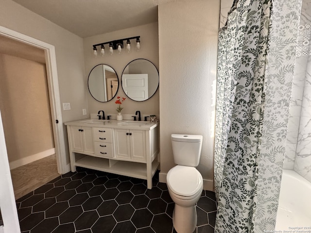 bathroom featuring a shower, tile patterned floors, vanity, and toilet