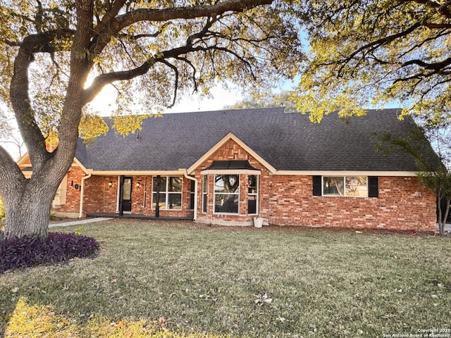 single story home featuring a front lawn