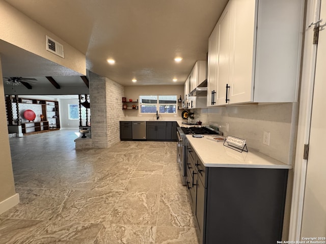 kitchen featuring ceiling fan, backsplash, gray cabinets, white cabinets, and appliances with stainless steel finishes