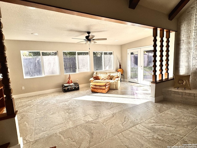 sunroom / solarium with ceiling fan and french doors