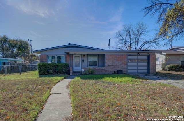 single story home featuring a garage and a front lawn