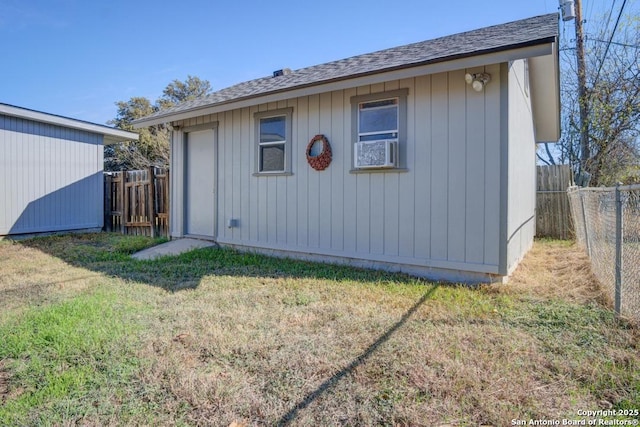 view of outbuilding featuring a lawn and cooling unit