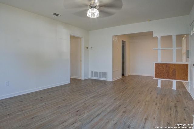 empty room with ceiling fan and light wood-type flooring