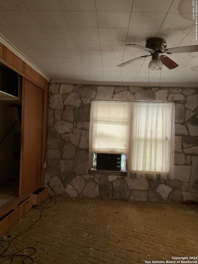 spare room with ceiling fan, cooling unit, and ornamental molding